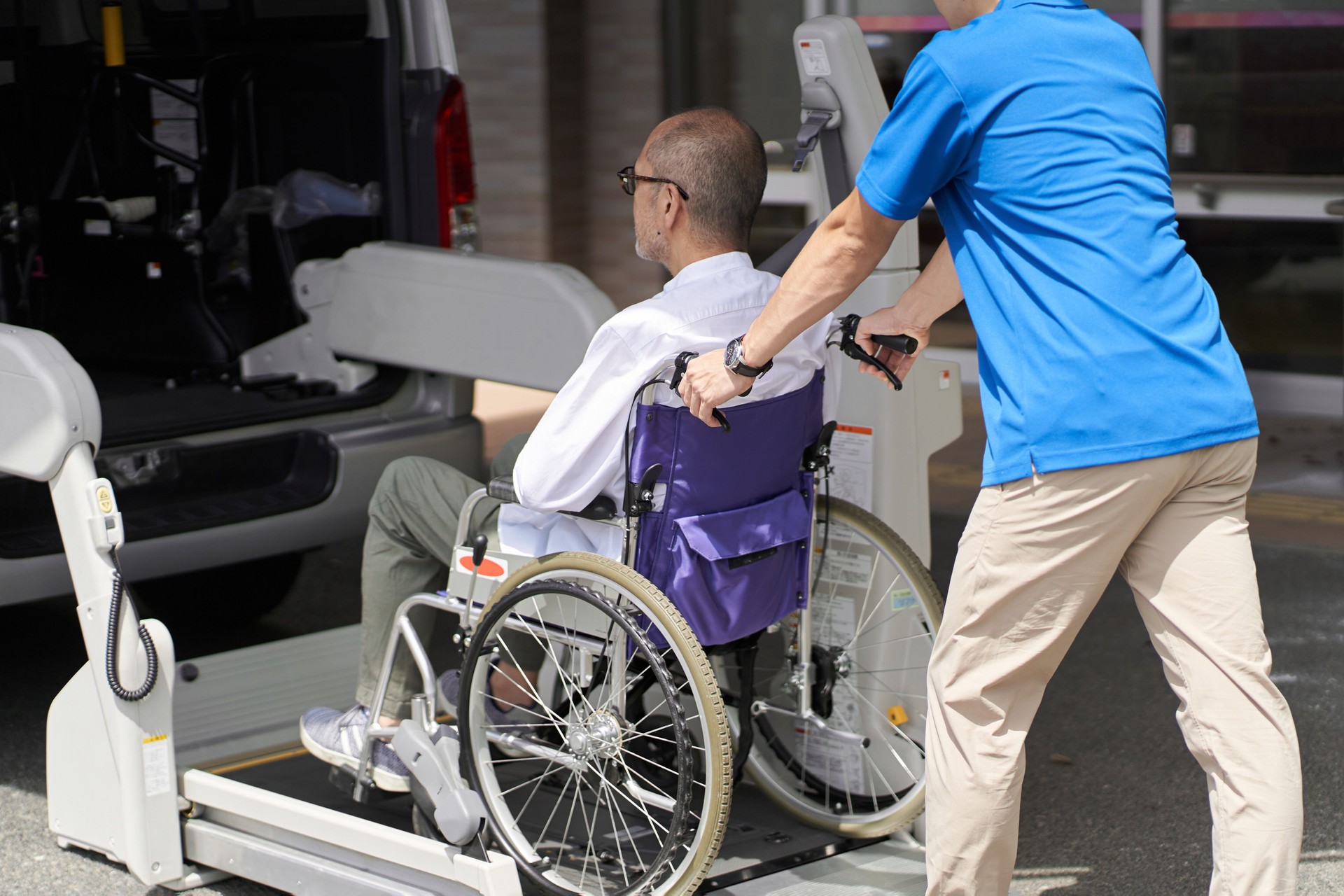 A caregiver who puts an elderly person in a long-term care taxi